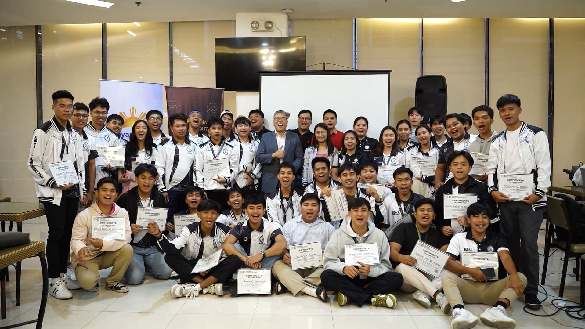 BayanAIhan participants holding their certificates of completion after a training session